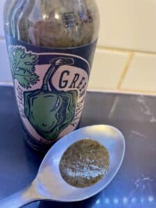 Green Belly Hot Sauce on a spoon