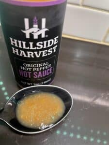 Hillside Harvest Original Hot Pepper Hot Sauce on a spoon