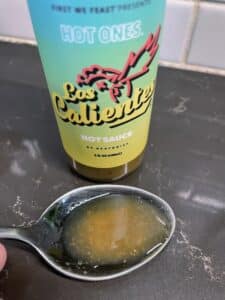 Hot Ones Los Calientes Hot Sauce on a spoon